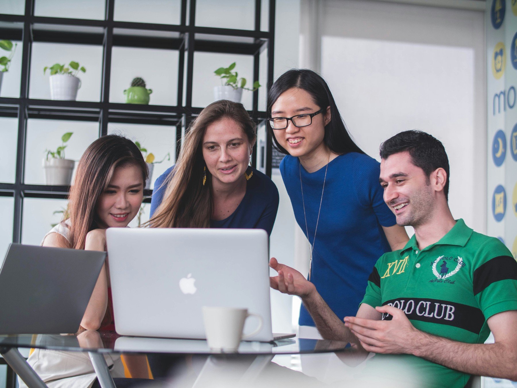 Young apprentices collaborating around a laptop